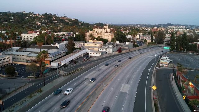 Aerial drone view of US 101- Freeway with no traffic during Coronavirus lockdown in Los Angeles, looking towards the Hollywood Hills in California, USA.