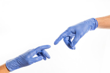 Hands of people in medical colorful rubber gloves reaching out for each other