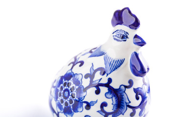Ceramic rooster artwork with painted textile designs.