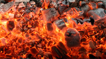 Burning coals texture background top view.