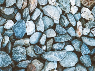 stone background, natural smooth colourful pebbles on the beach
