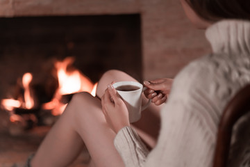 Beautiful girl with cup of tea relaxing at home