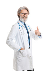 Portrait of senior male doctor showing thumb-up gesture on white background