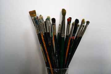 Set of brushes for creativity in a glass tassel up. Used drawing or handmade accessories