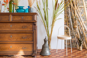 old antique old mahogany chest of drawers in a room with additional decor. interesting design