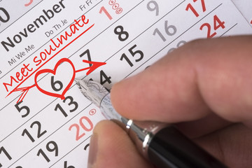 Meet or find soulmate concept with red heart shape and calendar date