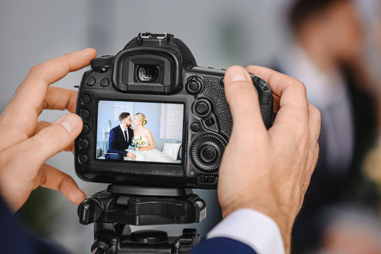 Photographer working with young wedding couple in studio, closeup