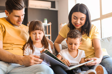 Happy family reading book at home