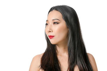 Naklejka premium Young Asian woman with beautiful hair on white background