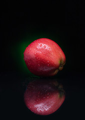 red apple on black background
