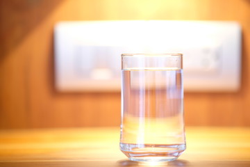 Water in glass on counter background and space for text 