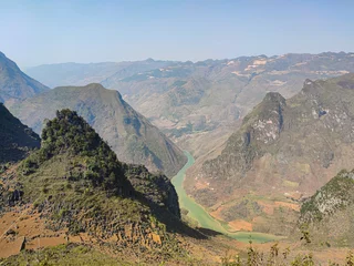 Fototapeten Long blue river in canyon. View from the green mountains. © find_me_on_map