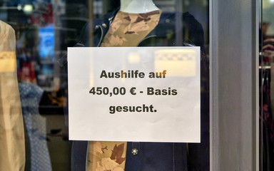 Job offer in German script on a sign in a market.