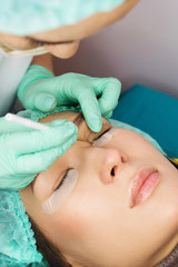 Eyelash care treatment procedures. Staining, curling, laminating for lashes. Beauty model with...
