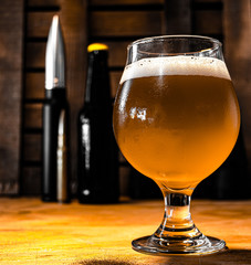 glass of beer on wooden table