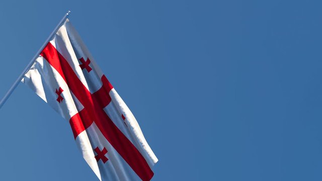 The national flag of Georgia is flying in the wind