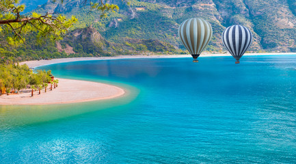 Hot air balloon flying over spectacular Oludeniz beach and lagoon