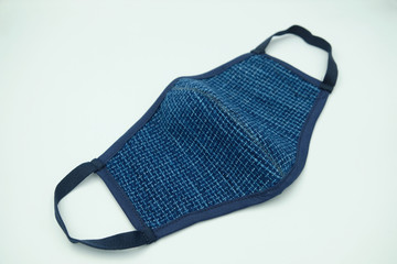 Blue indigo woven fabric cloth face mask For covid19 virus protection, made from woven fabric cotton for wearing to protect against Coronavirus isolated on a white background.