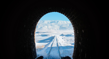 Fototapeta na wymiar Dark tunnel in the snowy mountains 