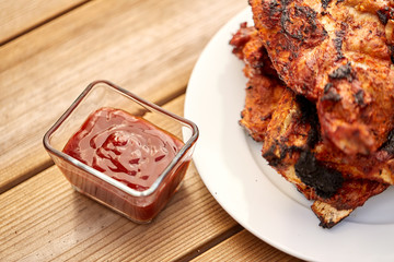 cooking, culinary and food concept - close up of grilled barbecue meat stack on plate