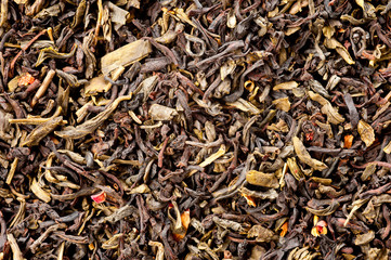 A mixture of black and green tea with vanilla-strawberry flavor, sliced strawberries and rose petals. Background for tea and antioxidants.