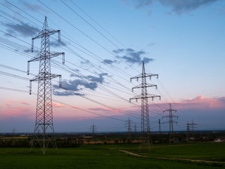 Pylons of a  high-voltage power on a sunset. Electrical industry.