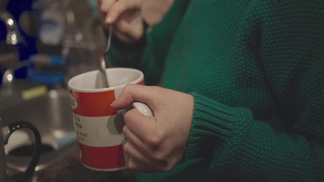 Person Stirring Hot Chocolate in a Mug- Close up Shot