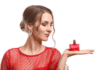 Fototapeta premium Beautiful young woman with bottle of perfume on white background
