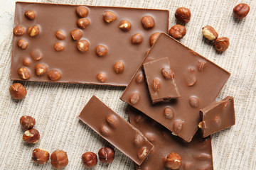 Sweet chocolate with nuts on light background