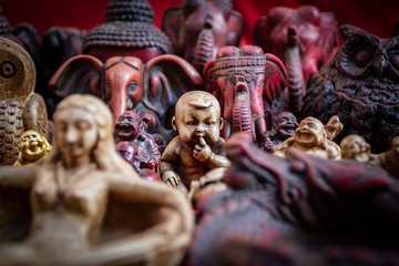Religious figurine of a baby in a cluttered market stall