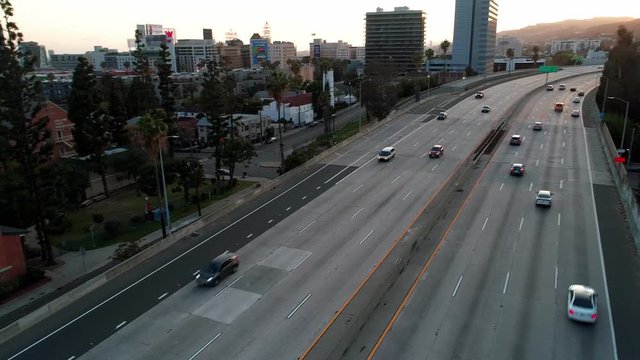 Covid-19 CoronaVirus is causing empty roads in America. Aerial view panning across freeway
