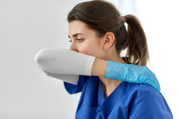 medicine, healthcare and people concept - doctor or nurse in gloves coughing covering mouth with...