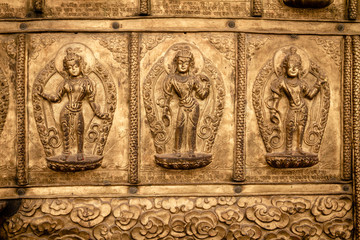 Three religious images in a golden temple facade, Bhaktapur