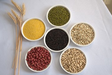 Collection of beans and cereals in bowls on white background, healthy food, vegetarian, supplemental nutrition, coronavirus prevention