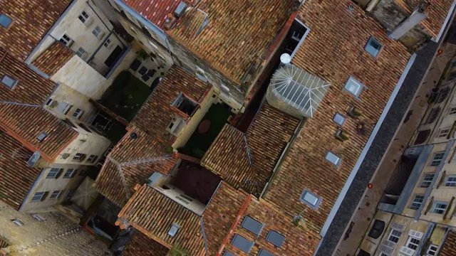 Drone footage over Bordeaux city on a sunny day, footage include old building and people are enjoying walking.