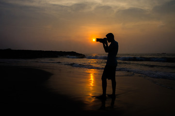 silhouette of a Photographer on the beach at sunset