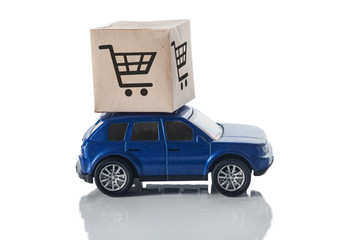 Car with a box on the roof isolated on a white background. The concept of fast delivery, transport logistics.