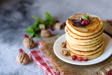 Delicious fresh beautiful pancakes with citrus honey and jam