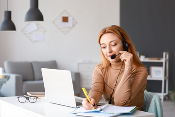 Mature woman using laptop for online learning at home
