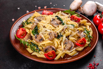 Pasta with mushrooms, cheese, spinach, rukkola and cherry tomatoes