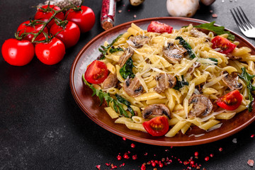 Pasta with mushrooms, cheese, spinach, rukkola and cherry tomatoes