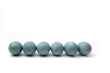a row of blue chicken eggs colored with natural dye