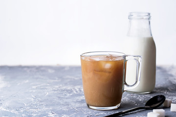 Fragrant custard with milk, spoon, sugar, concrete background.