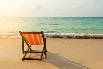 Beach chair on the sand beach with the sunlight