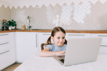 Homeschooling and distance education for students. Little child girl learn online at home school.