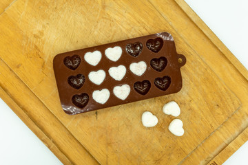DIY Cute Mini heart bath bomb from silicone chocolate mold on wooden tray