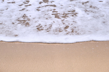 Calm Waves Washing Over a Beach on a Sunny Day