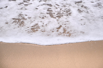 Calm Waves Washing Over a Beach on a Sunny Day