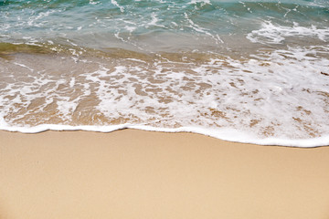 Calm Waves Washing Over a Beach on a Sunny Day