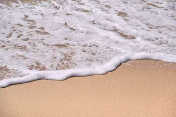 Calm Waves Washing Over a Beach on a Sunny Day